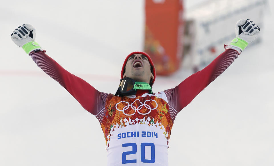 Men's supercombined gold medal winner Switzerland's Sandro Viletta celebrates on the podium during a flower ceremony at the Sochi 2014 Winter Olympics, Friday, Feb. 14, 2014, in Krasnaya Polyana, Russia. (AP Photo/Christophe Ena)