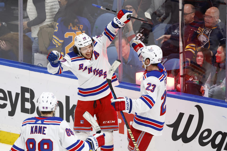 New York Rangers left wing Artemi Panarin (10) celebrates after his winning goal with defenseman Adam Fox (23) in the overtime period of an NHL hockey game against the Buffalo Sabres, Saturday, March 11, 2023, in Buffalo, N.Y. (AP Photo/Jeffrey T. Barnes)