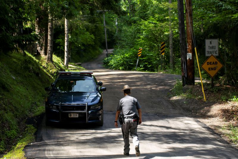 A New York State Trooper stands guard outside the home where attorney Roy Den Hollander was found dead after allegedly killing the son of federal judge Esther Salas and wounding her husband, in Catskills