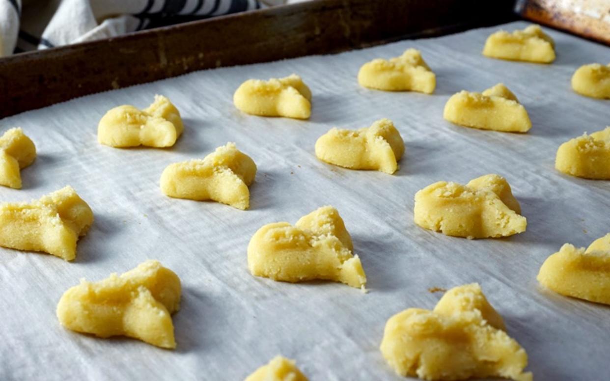 heart-pressed cookies on baking sheet how to make butter cookies