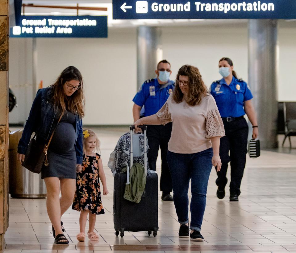 Travelers make their way through Will Rogers World Airport in Oklahoma City on Wednesday. Masks are now optional after a judge in Florida struck down the national mask mandate for mass transit.