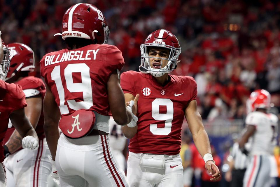 Crimson Tide quarterback Bryce Young (9) celebrates his rushing touchdown with tight end Jahleel Billingsley during the second quarter against the Bulldogs in the SEC championship game.