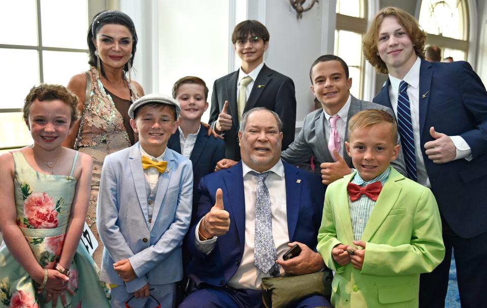 Howie and Suzie Schwab, with some of Dick Vitale's All-Courageous Team, Harper Harrell, 9, Cannon Wiggins, 11, Grayson Hermann, 9, Coleton Korney, 19, Enzo Grande, Weston Hermann, 16, and Arran Wiggins, 10, in the green.