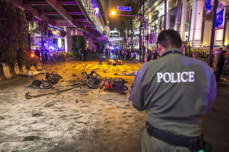 Bodies of victims are covered with white sheet among wreckages of motorcycles and other debris as security forces and emergency workers gather at the scene of the blast in central Bangkok August 17, 2015. REUTERS/Athit Perawongmetha