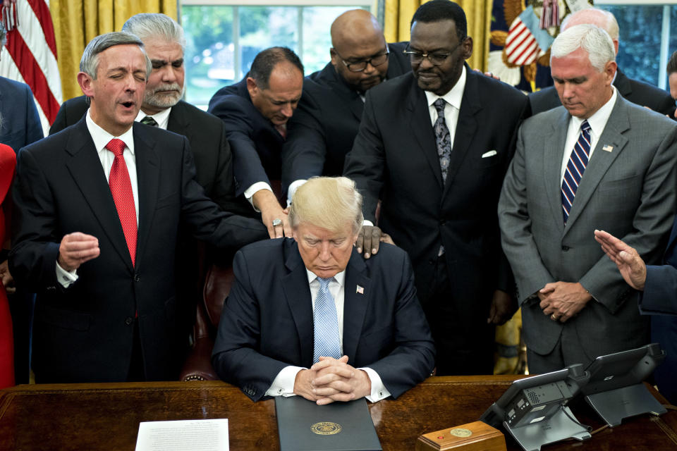 President Trump bows his head during a prayer while surrounded by U.S. Vice President Mike Pence, faith leaders and evangelical ministers after signing a proclamation declaring a day of prayer in the Oval Office of the White House in Washington, D.C., U.S., on Friday, Sept. 1, 2017. (Photo: Bloomberg via Getty Images)