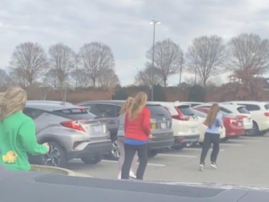 People running from Southpoint mall after shooting attack inside, in Durham, North Carolina, U.S. November 26, 2021 in this still frame obtained from social media video (LATEONYA JENKINS via REUTERS)
