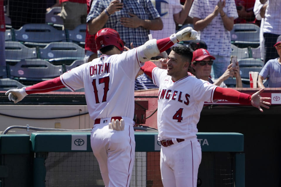 Los Angeles Angels' Shohei Ohtani, left, is congratulated by Jose Iglesias after hitting a solo home run during the fifth inning of a baseball game against the Boston Red Sox Wednesday, July 7, 2021, in Anaheim, Calif. (AP Photo/Mark J. Terrill)
