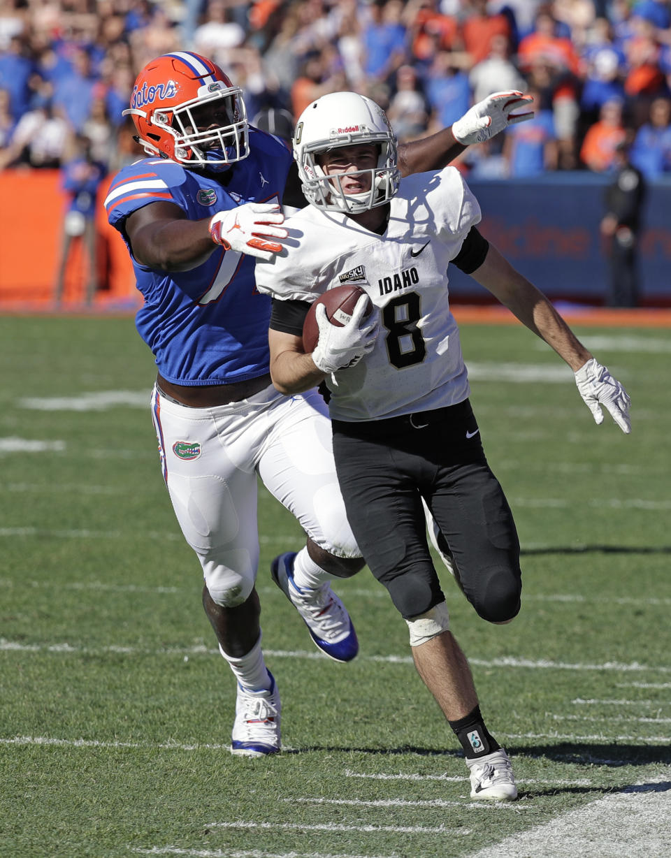 Idaho quarterback Mason Petrino (8) is forced out of bound by Florida defensive lineman Antonneous Clayton Sr. during the second half of an NCAA college football game, Saturday, Nov. 17, 2018, in Gainesville, Fla. (AP Photo/John Raoux)