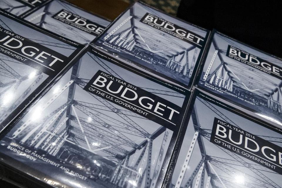 President Barack Obama's new $4 trillion budget plan is distributed by Senate Budget Committee staffer Eric Chalmers as it arrives on Capitol Hill in Washington, early Monday, Feb. 2, 2015. (AP Photo/J. Scott Applewhite)