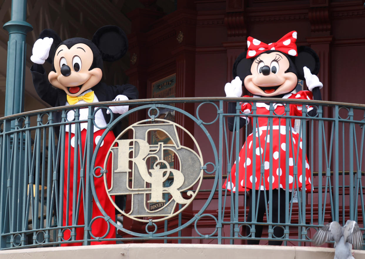 Disney characters Mickey Mouse and Minnie welcome visitors at Disneyland Paris as the theme park reopens its doors to the public in Marne-la-Vallee, near Paris, following the coronavirus disease (COVID-19) outbreak in France,  July 15, 2020.   REUTERS/Charles Platiau