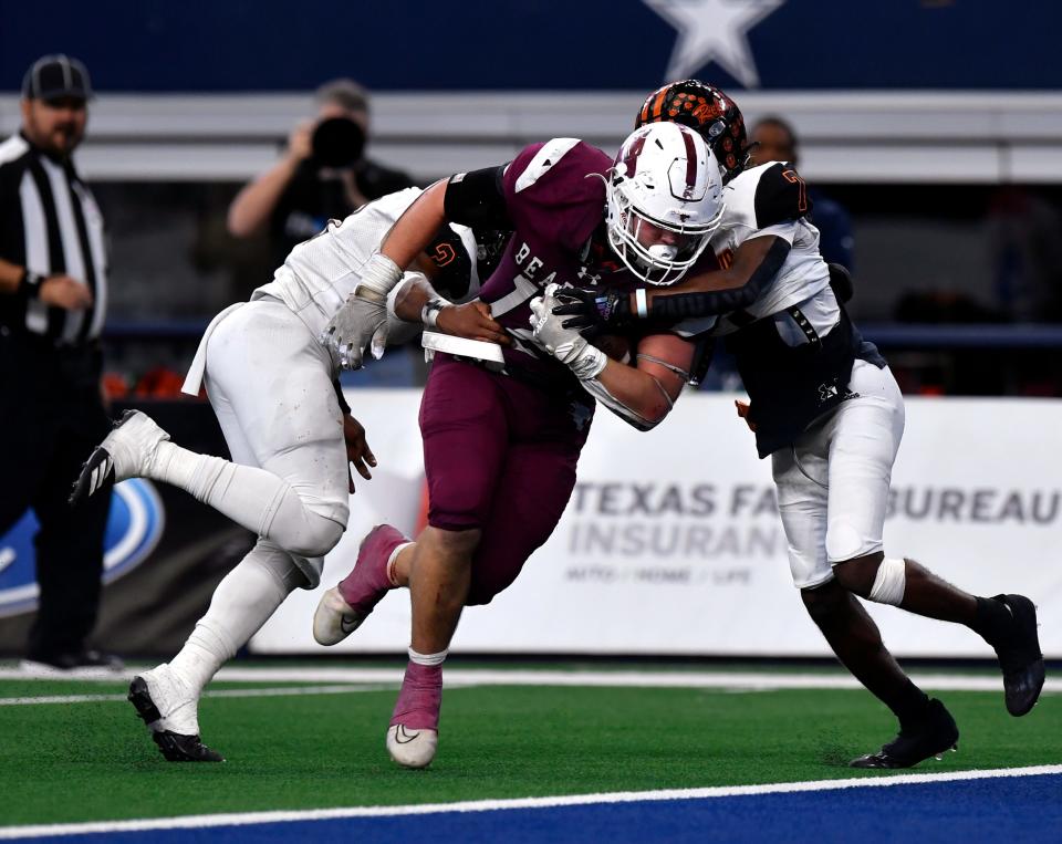 Refugio linebacker Zander Wills (left) and defensive back Jaedyn Lewis fail to stop Hawley running back Austin Cumpton from crossing the goal line for a touchdown during the Class 2A Div. I state football championship game Dec. 15 at AT&T Stadium. Hawley won 54-28.