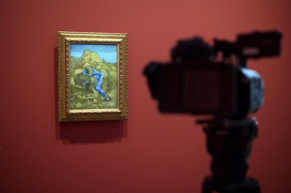 A man films a painting by Vincent Van Gogh entitled 'The Sheaf-Binder' (after Millet) during the exhibition 'Van Gogh in Provence: Modernizing Tradition' at the Fondation Vincent Van Gogh Arles on May 13, 2016 in Arles, southern France.&nbsp;