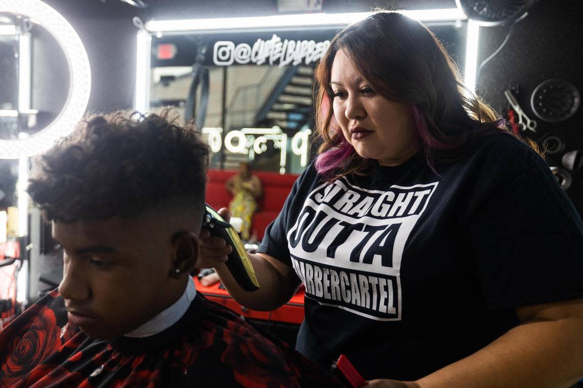 Owner Alisha Clark styles Sylis Conner’s hair Friday, Aug. 12, 2022, at Texas Barber Cartel in Watauga.