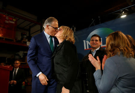 Washington state Governor Jay Inslee kisses his wife Trudi Inslee after a news conference to announce his decision to seek the Democratic Party's nomination for president in 2020 at A&R Solar in Seattle, Washington, U.S., March 1, 2019. REUTERS/Lindsey Wasson