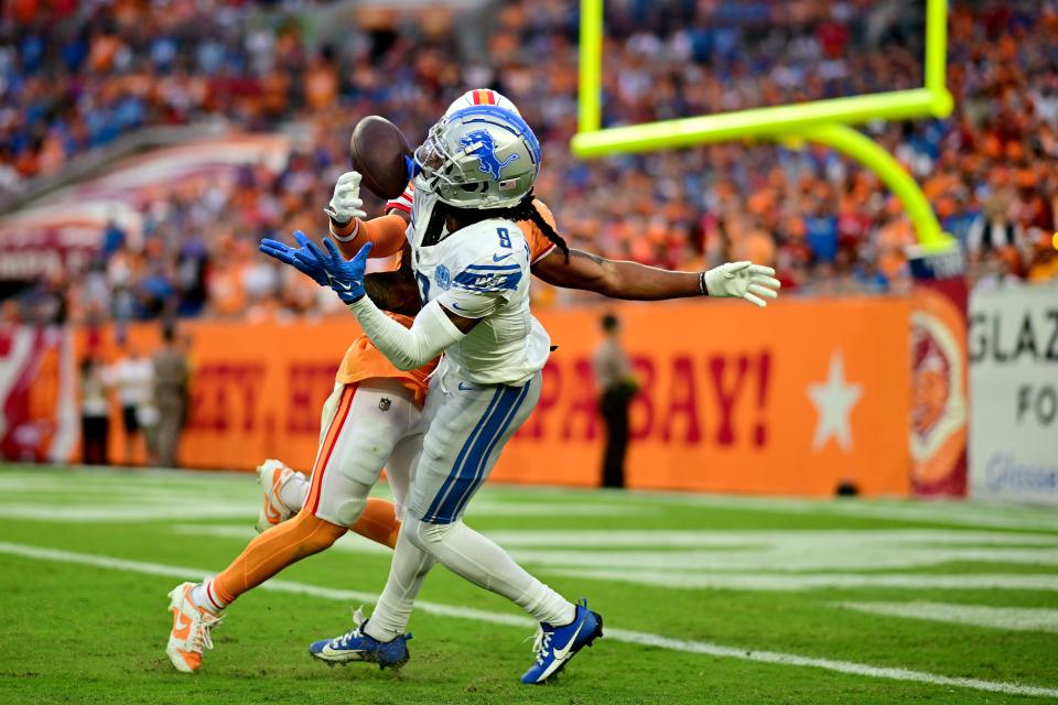 Jameson Williams catches a touchdown over Ryan Neal during the third quarter in Tampa, Oct. 15.