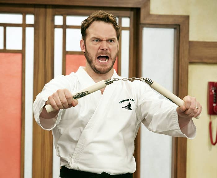 Andy from "Parks and Rec" holding nunchucks