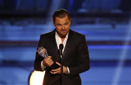 Leonardo DiCaprio accepts the award for best actor in a comedy for "The Wolf of Wall Street" during the 19th annual Critics' Choice Movie Awards in Santa Monica, California January 16, 2014. REUTERS/Mario Anzuoni