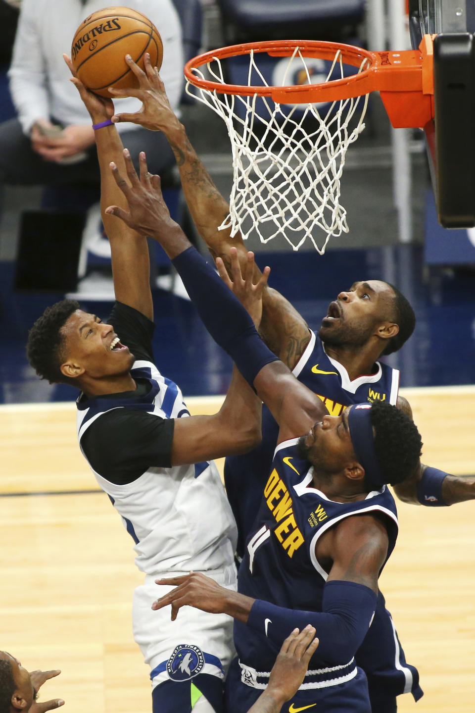 Minnesota Timberwolves Jarrett Culver (23) shoots against Denver Nuggets guards Paul Milsap (4) and Will Barton in the second quarter during an NBA basketball game, Sunday, Jan. 3, 2021, in Minneapolis. (AP Photo/Andy Clayton-King)