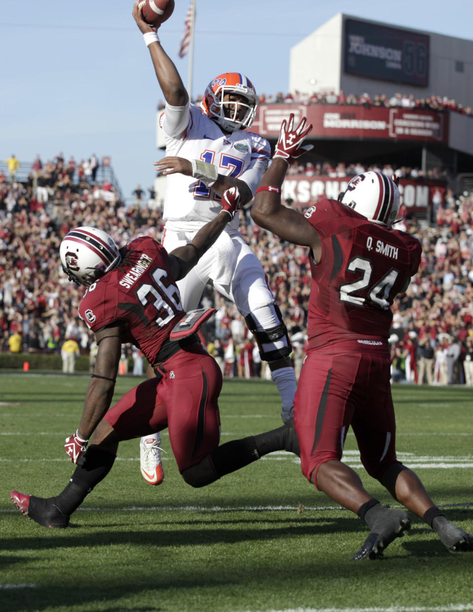 South Carolina safety D.J. Swearinger, left, and linebacker Quin Smith, right, rush Florida quarterback Jacoby Brissett, center, as he attempts to throw for a two- point conversion during the fourth quarter of a NCAA college football game, Saturday, Nov. 12, 2011, at Williams-Brice Stadium in Columbia, S.C. (AP Photo/Brett Flashnick)