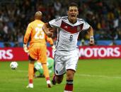 Germany's Mesut Ozil celebrates after scoring his team's second goal against Algeria during extra time in their 2014 World Cup round of 16 game at the Beira Rio stadium in Porto Alegre June 30, 2014. REUTERS/Darren Staples