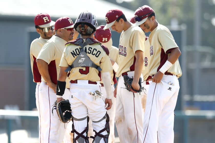 LOS ANGELES, CA - MAY 25: Roosevelt High starting pitcher Lino Zepeda (3), second from right, is surrounded by teammates against Chatsworth in the City Section Open Division baseball semifinal at Dedeaux Field on the campus of the University of Southern California on Wednesday, May 25, 2022 in Los Angeles, CA. Chatsworth won 4-3. (Gary Coronado / Los Angeles Times)