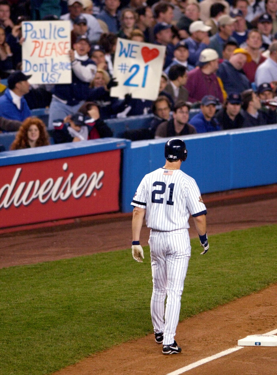 FILE - With fans showing their appreciation, New York Yankees baserunner Paul O'Neill stays close to third base after advancing on a Tino Martinez single in the first inning of World Series Game 5 against the Arizona Diamondbacks at Yankee Stadium Thursday, Nov. 1, 2001. O'Neill's No. 21 will be retired by the New York Yankees — on Aug. 21. The Yankees said Tuesday, Feb. 22, 2022, that they will hold Paul O'Neill Day ceremonies before that day's game against Toronto _ assuming the lockout ends and the 2022 season is played. (AP Photo/Ron Frehm, File)