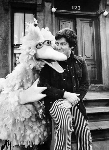 Fall River native Joe Raposo sits on the stoop on the set of "Sesame Street" with Big Bird. Raposo wrote the show's theme song as was its longtime musical director.