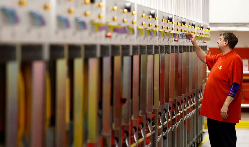 FILE PHOTO: A member of staff arranges forms at the Mount Pleasant mail centre in London