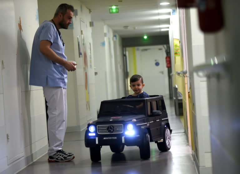 A two-year-old happily drives his way to the operating room at a hospital in Valenciennes in northern France