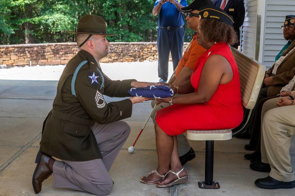 Pat Liddell of American Legion Post 333 receives the flag for retired Staff Sgt. Robert J. Wolfenberger Jr. during an interment ceremony for Wolfenberger at Fort Mitchell National Ceremony in Fort Mitchell, Alabama.