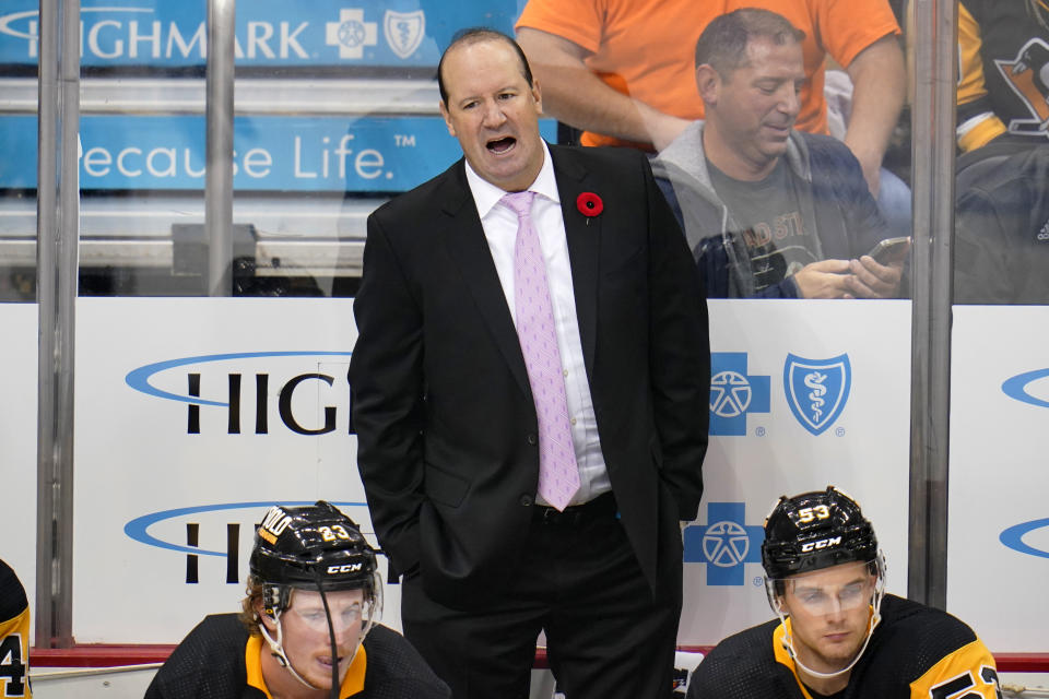 Pittsburgh Penguins assistant coach Todd Reirden stands behind the bench during the first period of the team's NHL hockey game against the Philadelphia Flyers in Pittsburgh, Thursday, Nov. 4, 2021. Reirden was filling in for coach Mike Sullivan, who tested positive for COVID-19. (AP Photo/Gene J. Puskar)