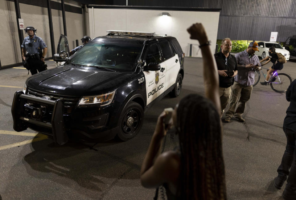 Protesters clash with police after a vigil held for Winston Boogie Smith Jr. early Saturday, June 5, 2021. Smith was shot and killed by law enforcement officers on Thursday during an arrest warrant operation. (AP Photo/Christian Monterrosa)