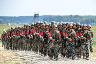 <p>Soldiers of the People’s Liberation Army (People’s Republic of China) march in formation during the Open Water contest between pontoon bridge units at the 2018 International Army Games on the Oka River, Vladimir Region, Russia, Aug. 3, 2018. (Photo: Sergei Bobylev/TASS via Getty Images) </p>