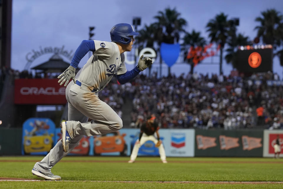 Los Angeles Dodgers' Freddie Freeman runs to first base after hitting an RBI single during the third inning of a baseball game against the San Francisco Giants in San Francisco, Saturday, Sept. 17, 2022. (AP Photo/Jeff Chiu)