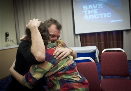 Greenpeace International activists Phil Ball of Britain and Camila Speziale (R) of Argentina show their relief following a decision by the Russian Parliament adopting an amnesty ending legal proceedings against the Arctic 30, in this December 18, 2013 handout from Greenpeace. REUTERS/Dmitri Sharomov/Greenpeace/Handout via Reuters