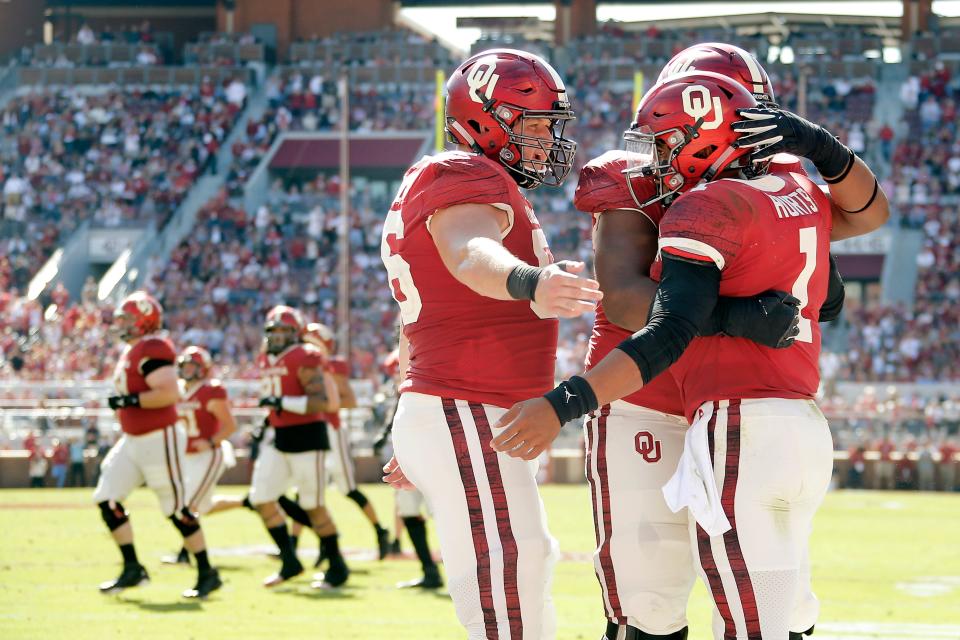 Oklahoma's Creed Humphrey (56), Tyrese Robinson (52) and Jalen Hurts (1) celebrate after a touchdown during a college football game between the University of Oklahoma Sooners (OU) and the West Virginia Mountaineers at Gaylord Family-Oklahoma Memorial Stadium in Norman, Okla, Saturday, Oct. 19, 2019. Oklahoma won 52-14. [Bryan Terry/The Oklahoman]