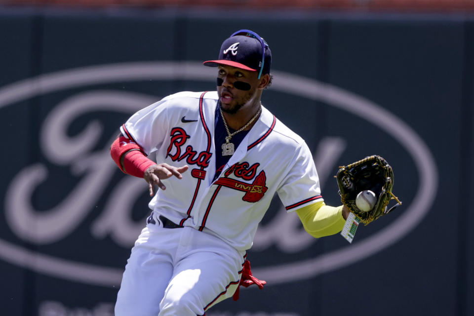 Atlanta Braves right fielder Ronald Acuna Jr. fields a hit from Los Angeles Angels' Jo Adell during the first inning of a baseball game Sunday, July 24, 2022, in Atlanta. (AP Photo/Butch Dill)