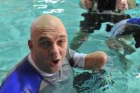 French Philippe Croizon, 44, celebrates on January 10, 2013 after becoming the first quadruple amputee to dive at a depth of 33 meters in the deepest swiming pool in the world in Brussels. He used flippers attached to prosthetic limbs to dive to the bottom of the pool with a group of 15 Belgian divers to set a new world record for an amputee. Croizon had all four limbs amputated in 1994 after being struck by an electric shock of more than 20,000 volts as he tried to remove a TV antenna from a roof. He has swum across the English Channel and all five intercontinental channels. AFP PHOTO GEORGES GOBETGEORGES GOBET/AFP/Getty Images