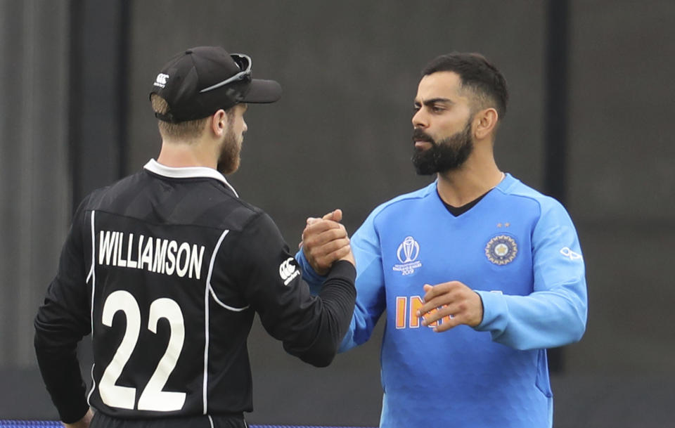 India's captain Virat Kohli, right, congratulates New Zealand's captain Kane Williamson for winning their Cricket World Cup semifinal match at Old Trafford in Manchester, Wednesday, July 10, 2019. (AP Photo/Rui Vieira)