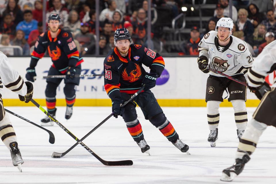 Jesper Froden (#28) skates down the ice with the puck during the AHL Calder Cup Finals game between the Coachella Valley Firebirds and the Hershey Bears at Acrisure Arena in Palm Desert, CA on June 8, 2023.