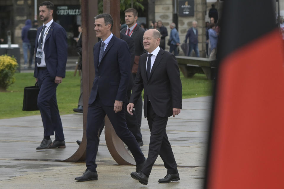 Spanish Prime Minister Pedro Sanchez, centre left, and German Chancellor Olaf Scholz walk together before the start of a summit in A Coruna, Spain, Wednesday Oct. 5, 2022. Leaders of Spain and Germany are meeting in northwestern Spain for a one-day summit focusing on Europe's energy crisis and consequences of the Russian invasion of Ukraine. (M.Dylan/Europa Press via AP)