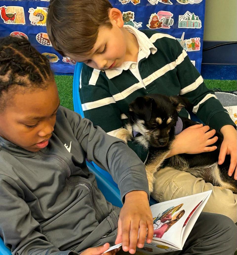 PHOTO: Students have to get their work done in order to earn “puppy time” to read to the animals. (Brooke Hughes/Foster Tales Puppy Therapy)