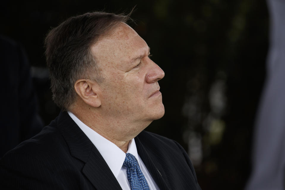 Secretary of State Mike Pompeo listens as President Donald Trump speaks during an Armed Forces welcome ceremony for the new chairman of the Joint Chiefs of Staff Gen. Mark Milley, Monday, Sept. 30, 2019, at Joint Base Myer-Henderson Hall, Va. (AP Photo/Evan Vucci)