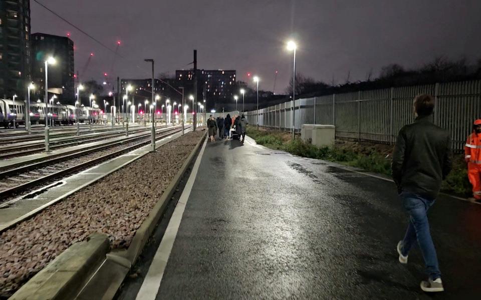 Passengers after being evacuated from trains stuck on the Elizabeth Line