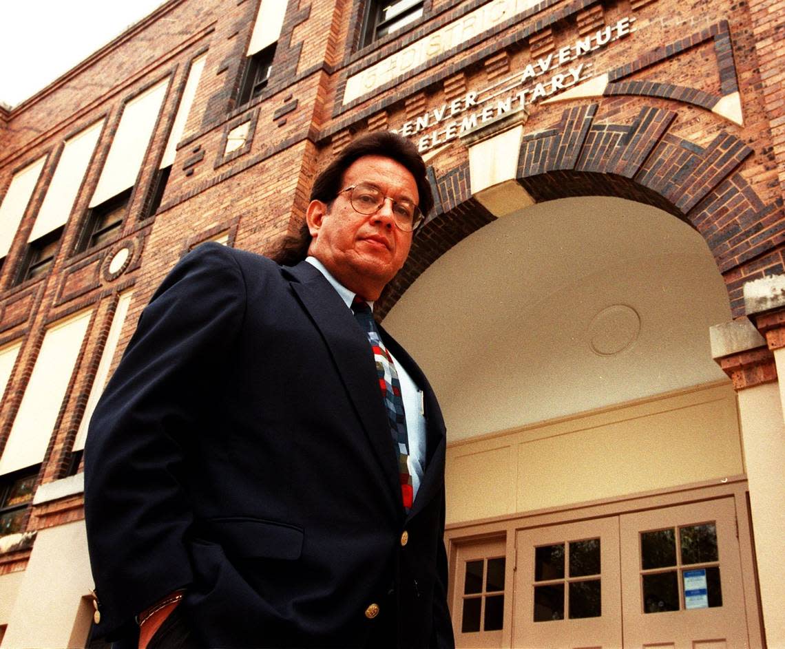 In this Dec. 3, 1998, photo, Rufino Mendoza Jr. stands before Denver Avenue Elementary School ahead of presenting a petition to the Fort Worth school district to rename the campus after his father, Rufino Mendoza Sr.