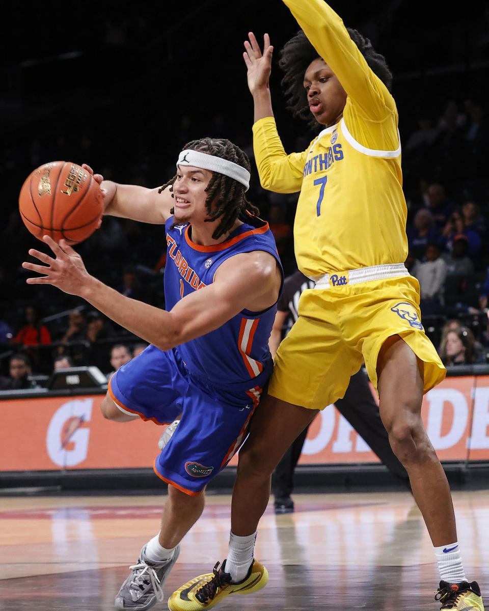 Florida guard Walter Clayton Jr. drives against Pittsburgh guard Carlton Carrington (7) during the second half of an NCAA college basketball game in the NIT Season Tip-Off on Wednesday, Nov. 22, 2023, in New York. (AP Photo/Eduardo Munoz Alvarez)