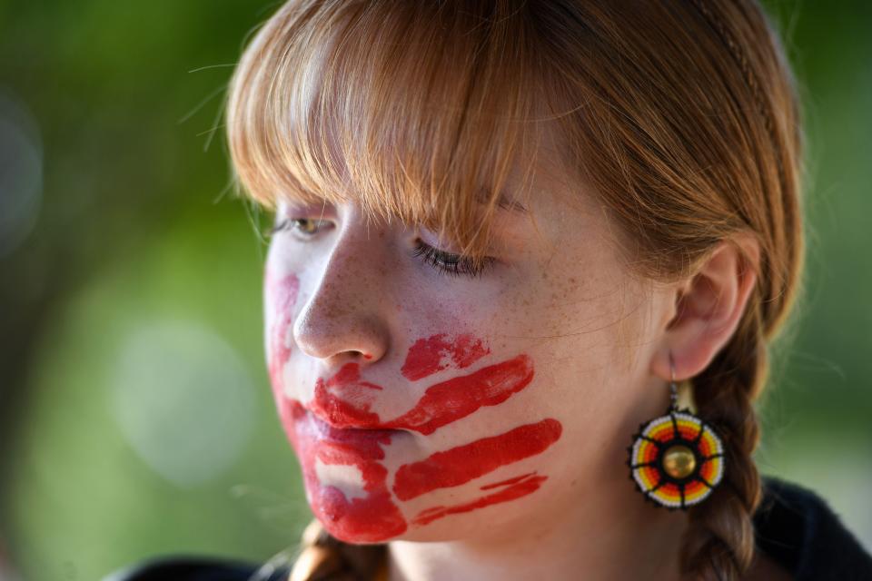 Rosalia Szameit, a Washington High School student who is Oglala Lakota, listens to her peers speak during a walkout commemorating thousands of missing and murdered Indigenous women on Thursday, Oct. 5, 2023 at Linwood Park in Sioux Falls, South Dakota.