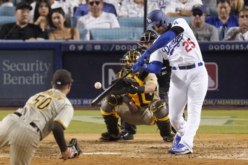 Los Angeles Dodgers' Trayce Thompson, right, hits a three-run home run as San Diego Padres relief pitcher Adrian Morejon.