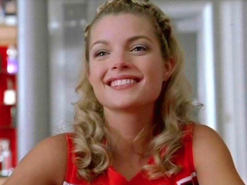 clare kramer wearing red cheerleading outfit in bring it on