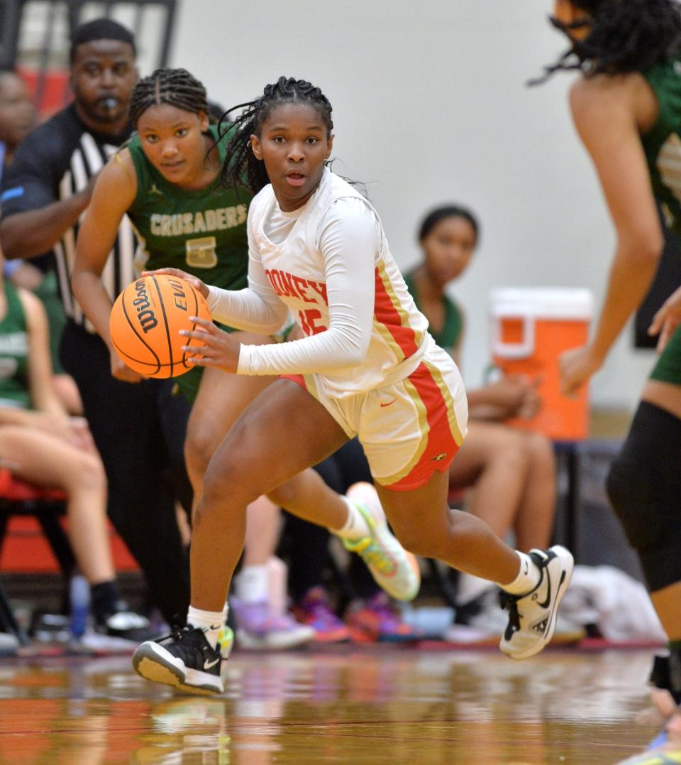 Mooney's Sy'monique Simon (#15) looks for an open teammate during a fast break. Cardinal Mooney hosted Tampa Catholic in the girls basketball regional semi-final on Tuesday night. 